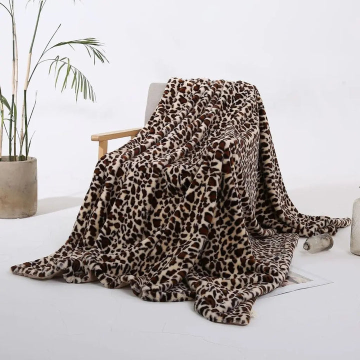 Leopard Print Velvet Throw Blanket draped over a sofa