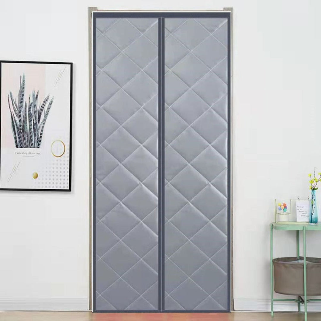 Gray magnetic thermal door curtain fitted to a doorway