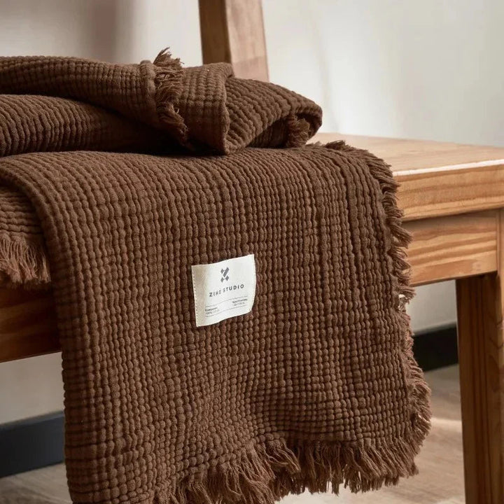 Brown Waffle Cotton Throw draped over armrest