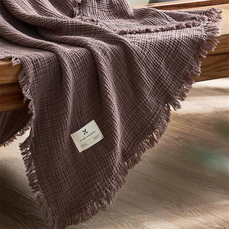 White Waffle Cotton Throw folded on couch