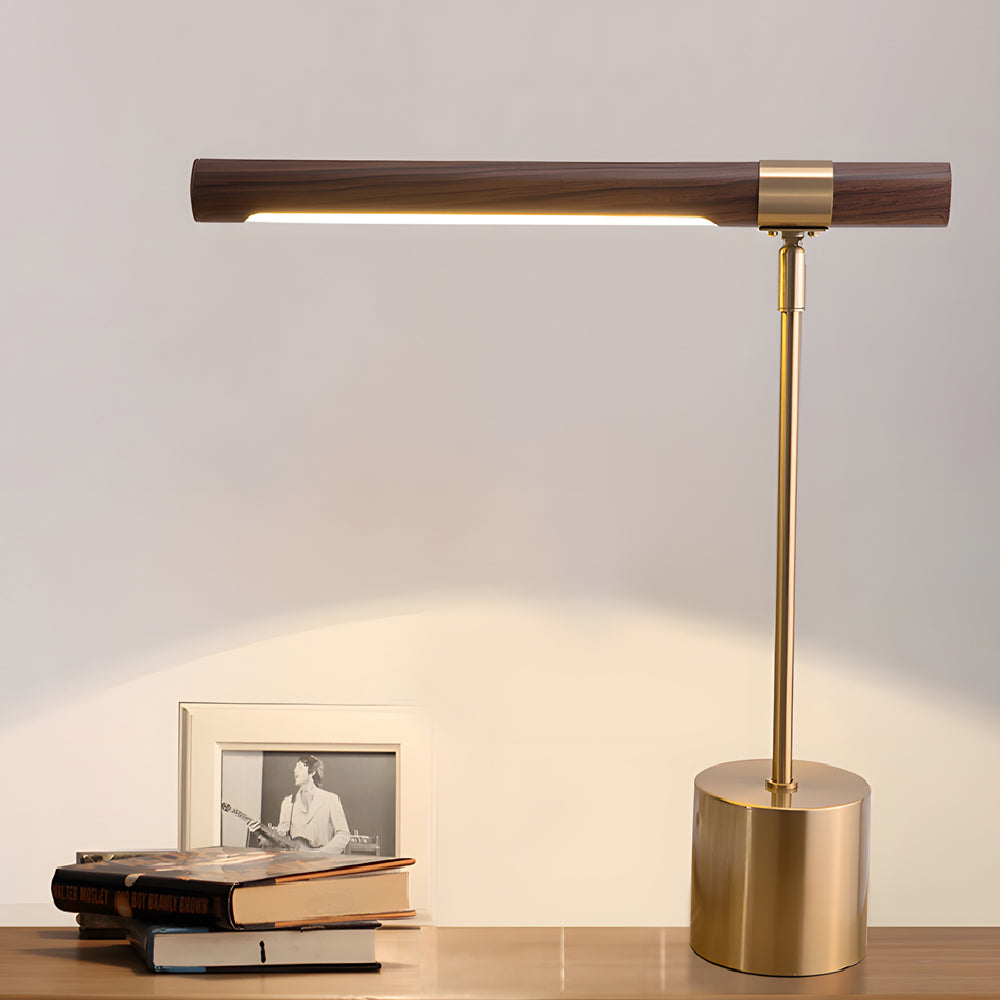 Wood Brass Task Lamp glowing beside stack of books