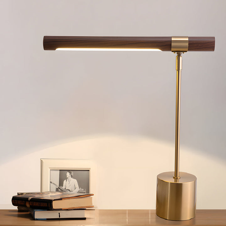 Wood Brass Task Lamp glowing beside stack of books