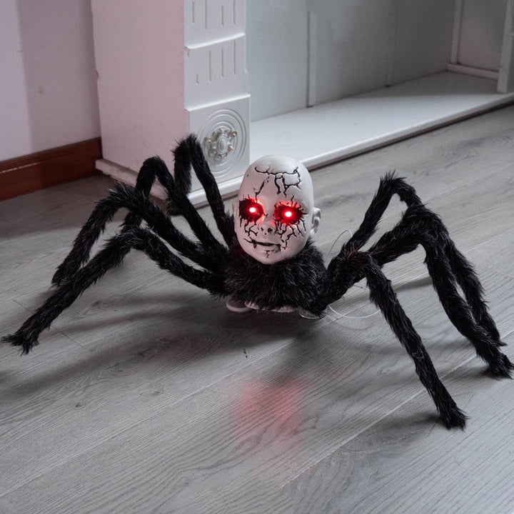 Black animatronic Halloween spider prop with doll-face design and glowing red eyes