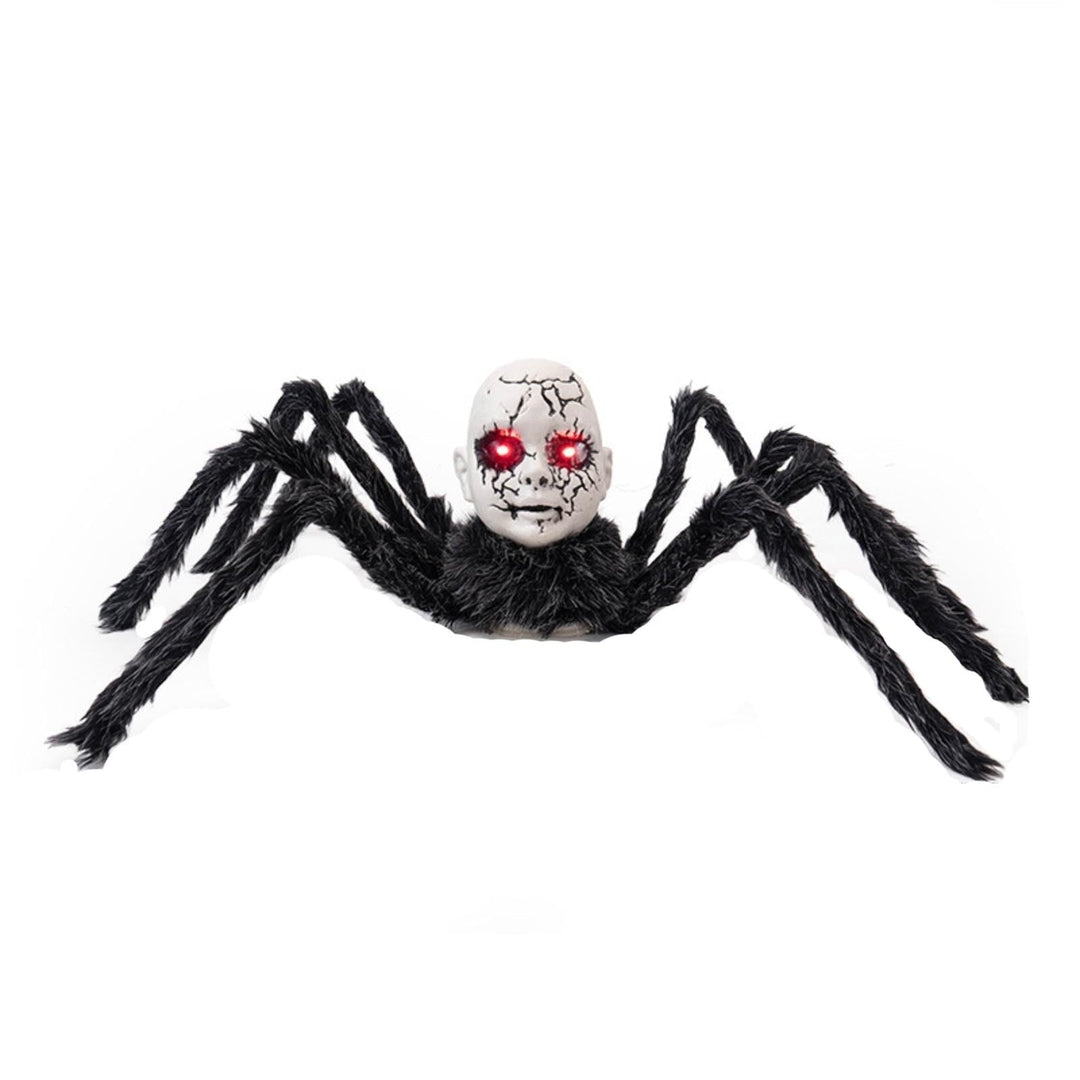 Motion-activated spider prop close-up showing glowing red eyes