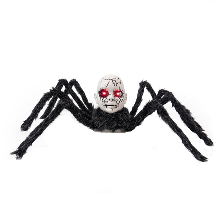 Motion-activated spider prop close-up showing glowing red eyes
