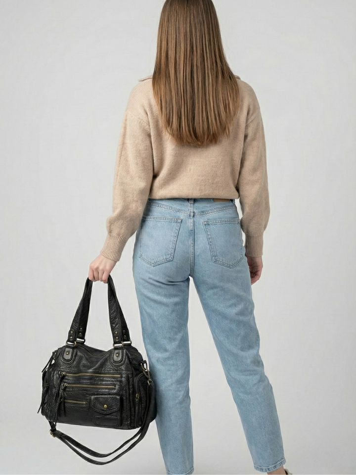 Black Multi-Pocket Vegan Leather Shoulder Bag carried by hand