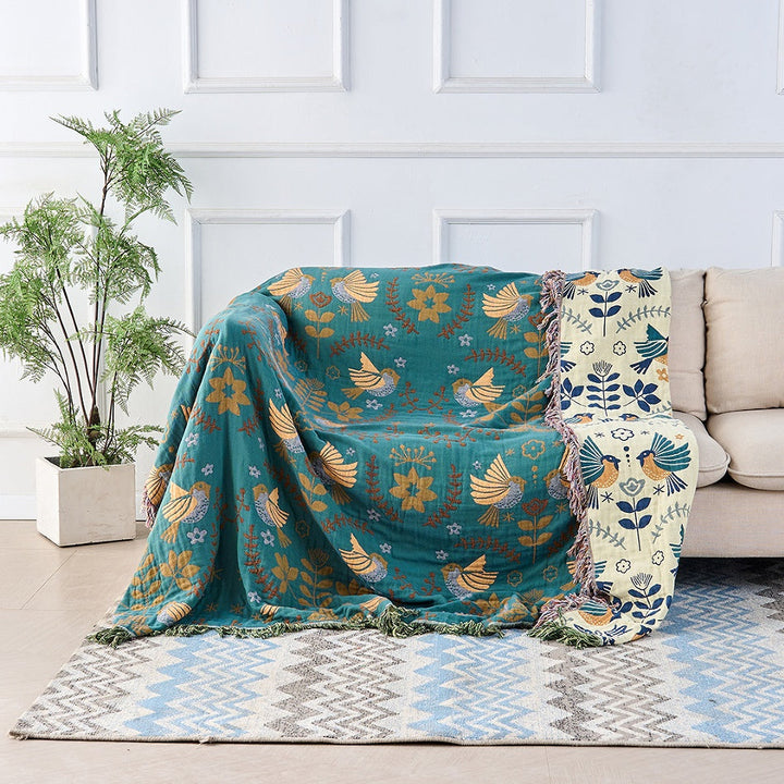 Nordic Bird Jacquard Cotton Throw draped over a bed
