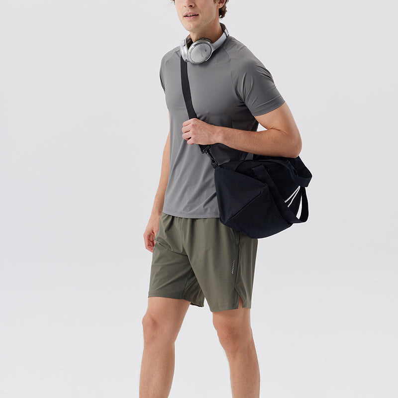 Green Nylon Stretch Athletic Shorts worn with gym bag