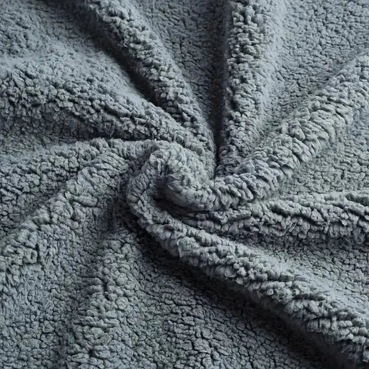 Black Plush Waterproof Throw Blanket on a bed