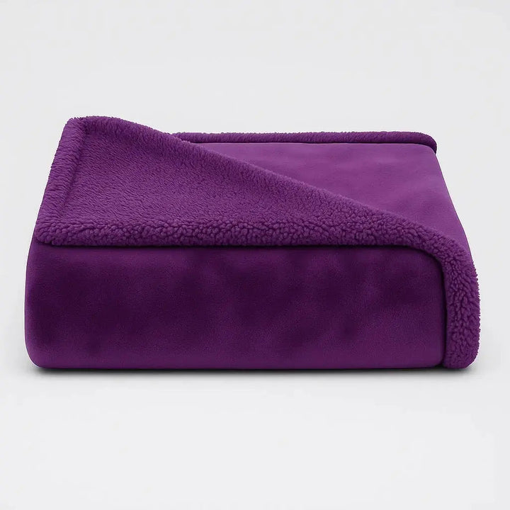 Plush Waterproof Throw Blanket on a bed