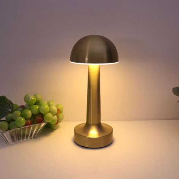 Gold Rechargeable Cordless Mushroom Table Lamp lit on dining table