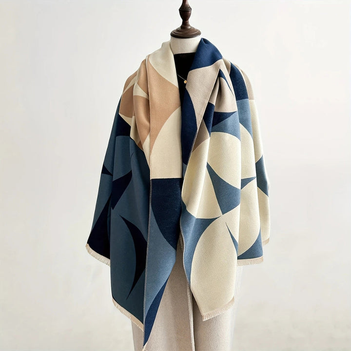 Blue and cream Reversible Geometric Poncho Scarf draped on mannequin