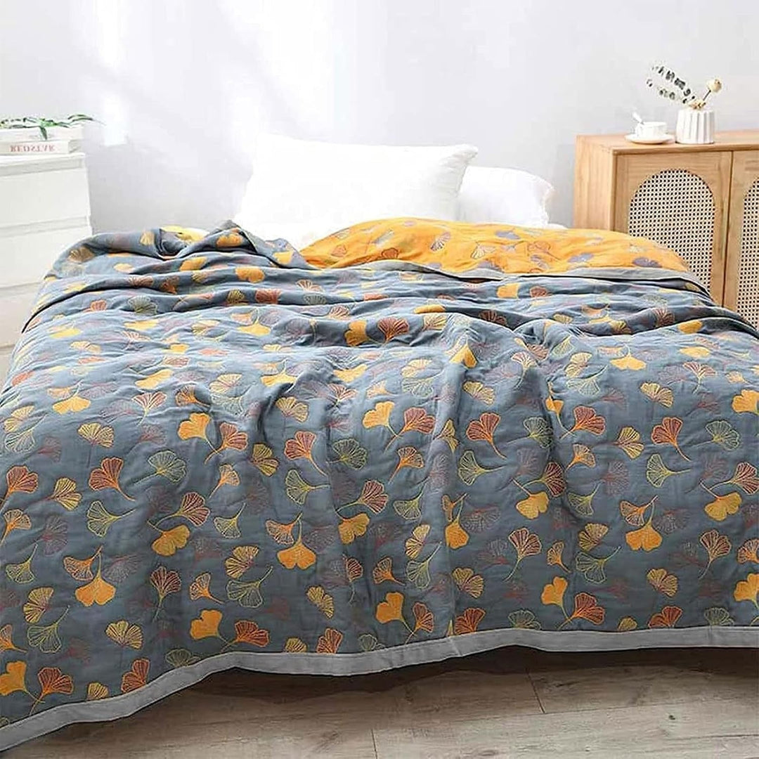 Reversible Ginkgo Cotton Gauze Throw covering a bed
