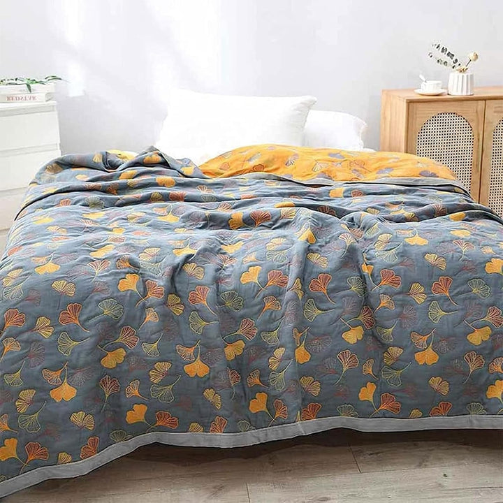 Reversible Ginkgo Cotton Gauze Throw covering a bed