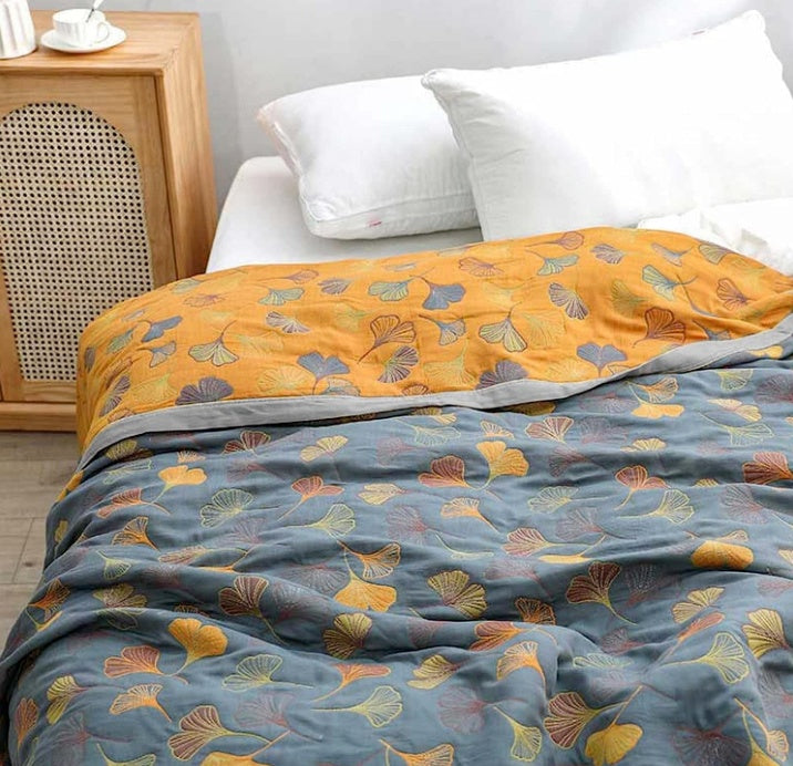 Reversible Ginkgo Cotton Gauze Throw styled on a bed