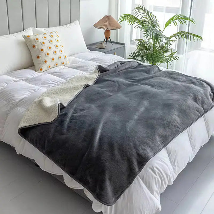 Gray Reversible Waterproof Pet Blanket on a sofa with a dog