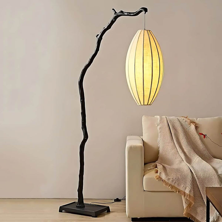 Black Sculptural Branch Floor Lamp beside armchair