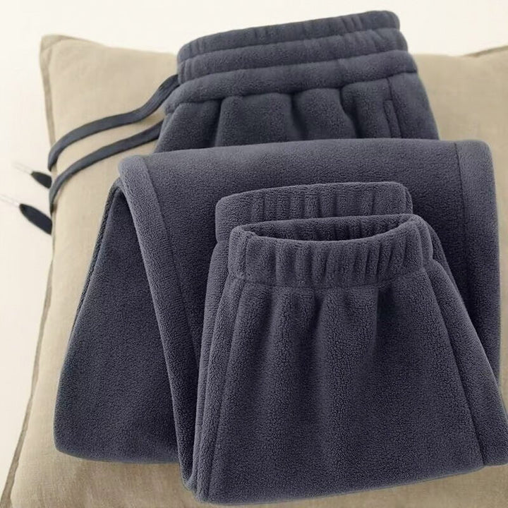 Dark Gray Soft Fleece Pants folded on a cushion