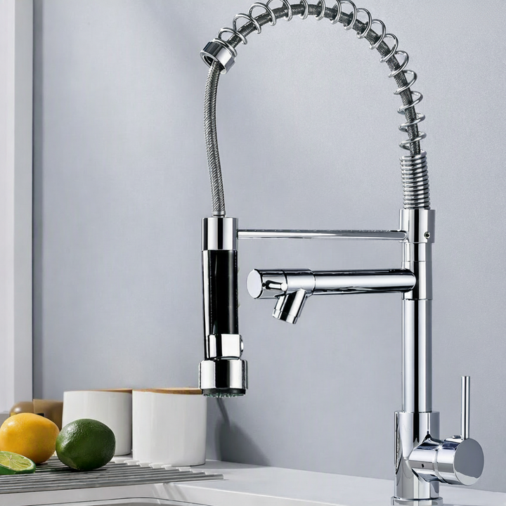 Chrome Spring-Neck Pull-Down Kitchen Faucet on white sink