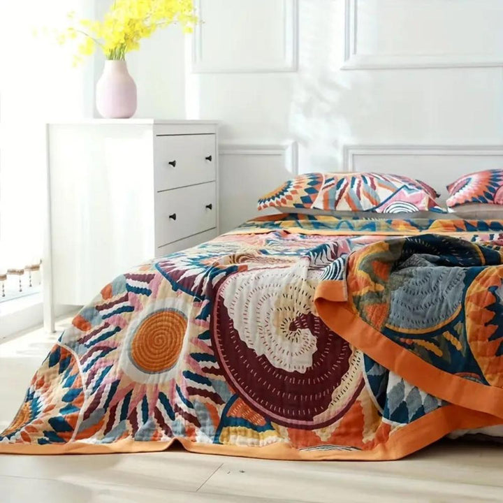 Sunburst Medallion Reversible Cotton Throw on a made bed