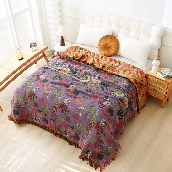 Orchid Bloom Tasseled Botanical Jacquard Cotton Throw on a bed
