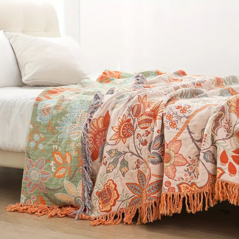 Multicolor floral cotton throw blanket on bed