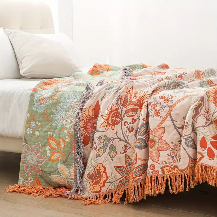 Multicolor floral cotton throw blanket on bed