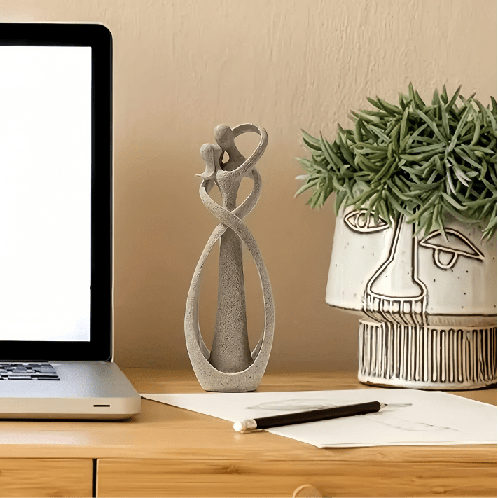 Sand Textured Ceramic Couple Sculpture on desk with plant