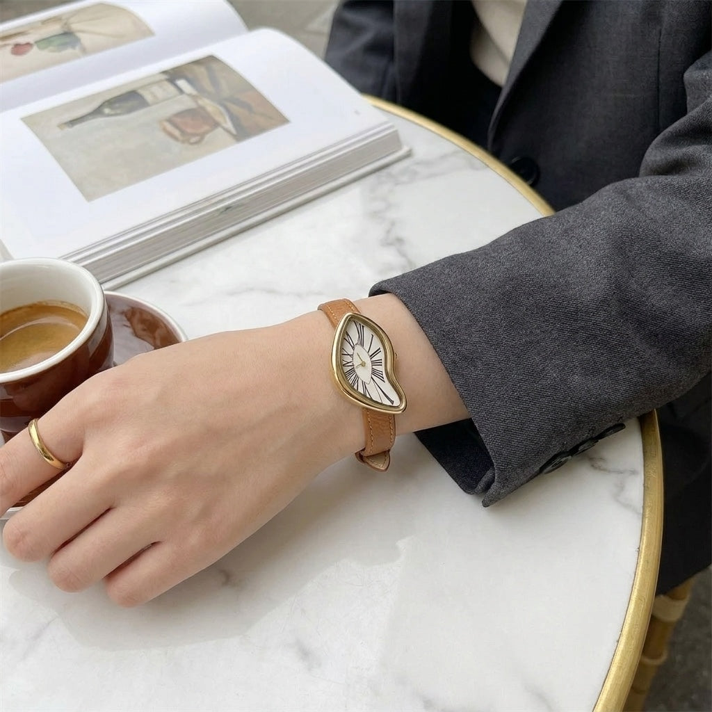 Chestnut Twisted Gold-Tone Watch worn at a cafe table