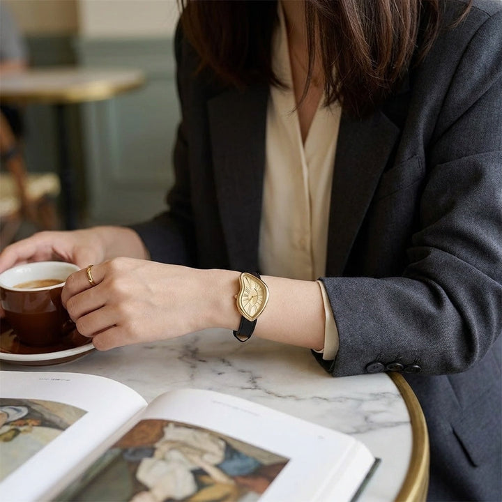 Royale Twisted Gold-Tone Watch worn at a cafe table