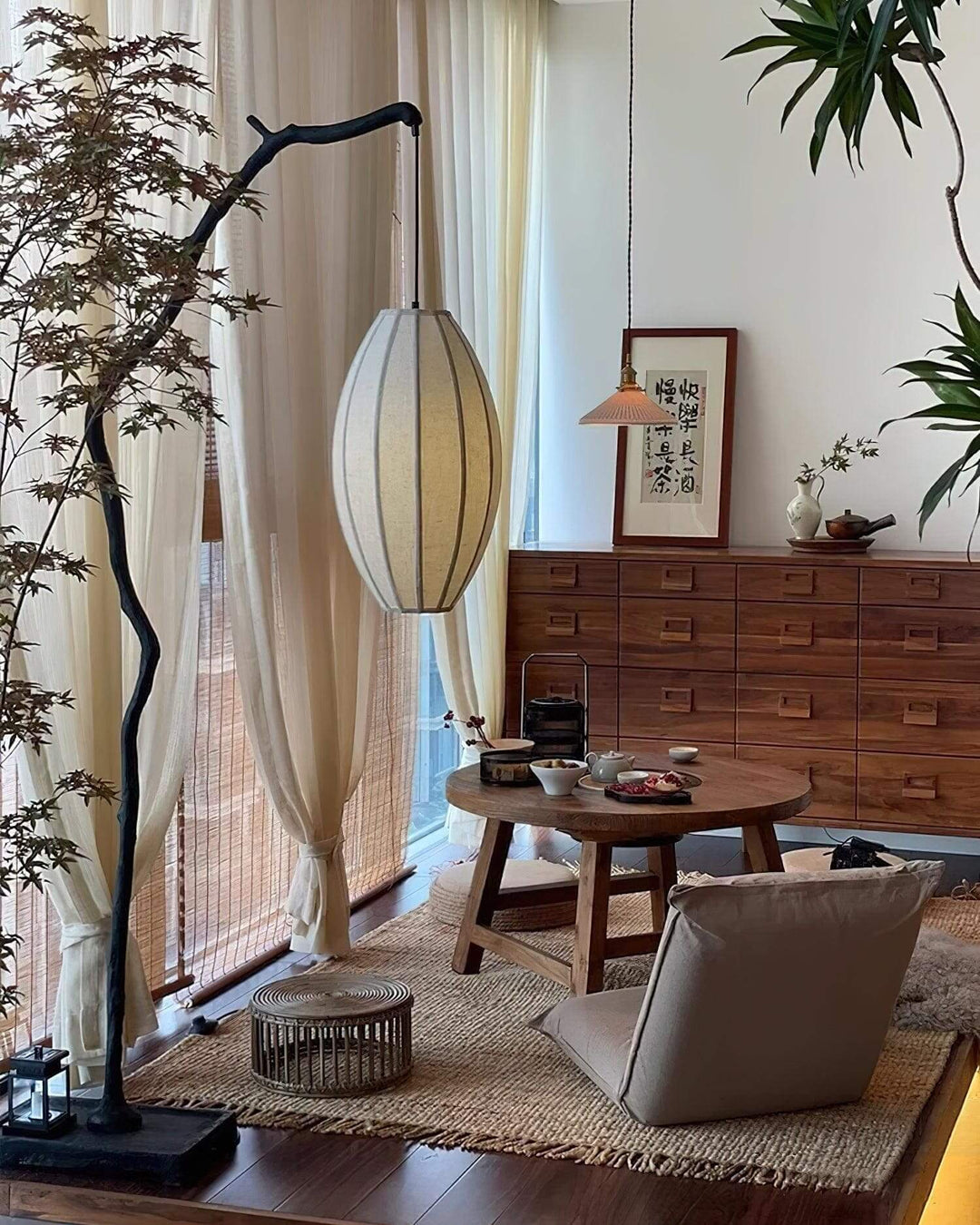 Tree floor lamp beside a lounge chair and wooden dresser in a living room.
