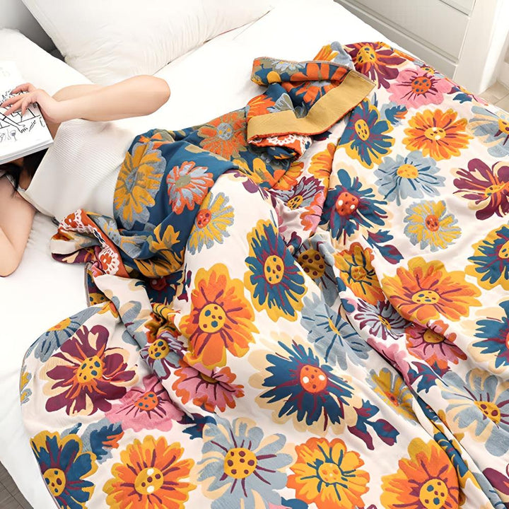 Vivid Floral Cotton Throw styled on a bed