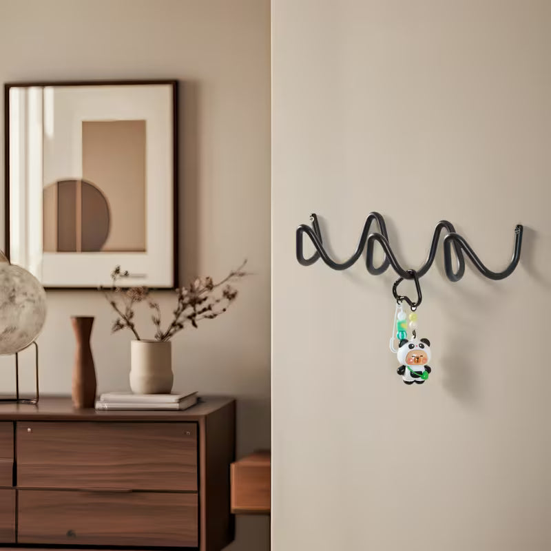 Black Wavy Iron Wall Coat Hooks mounted in living room