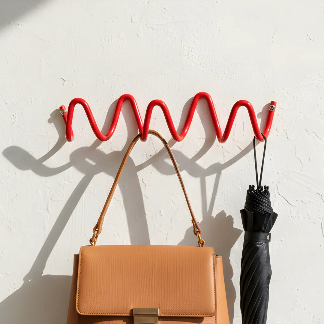 Red Wavy Iron Wall Coat Hooks holding bag and umbrella