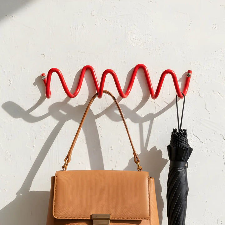 Red Wavy Iron Wall Coat Hooks holding bag and umbrella