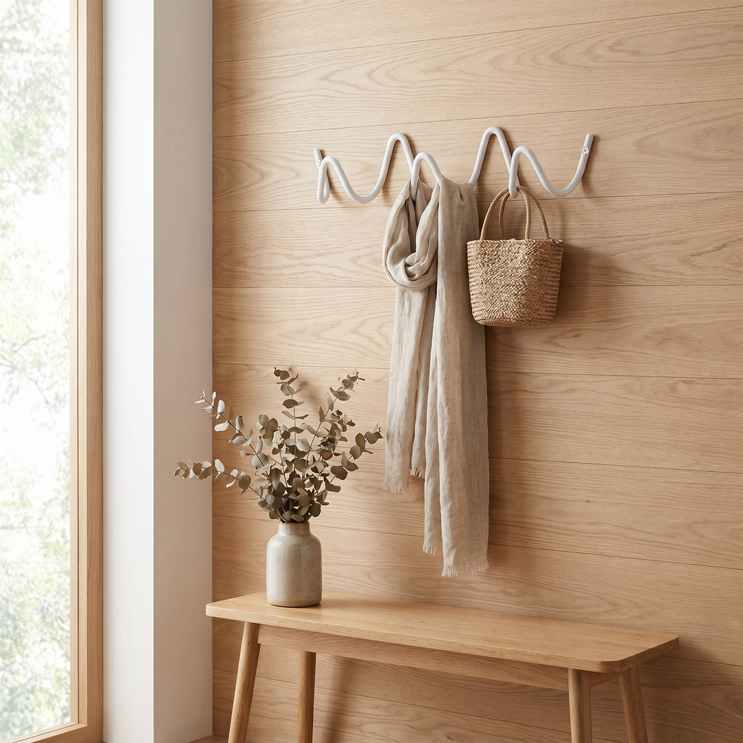 White Wavy Iron Wall Coat Hooks in entryway with scarf and bag