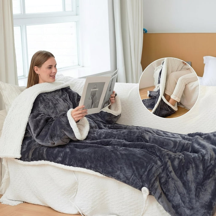 Dark grey wearable heated blanket used on a bed
