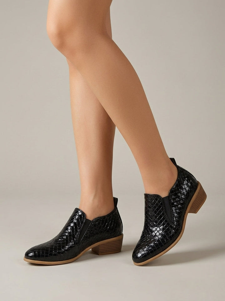 Black woven-texture slip-on ankle boots worn on model